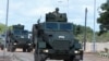 FILe - A Somalia National Army (SNA) soldier rides on an armored personnel carrier during celebrations on their 62nd anniversary in Mogadishu, Apr. 12, 2022. 