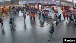 吉隆坡国际机场的监控录像显示一名据信是金正男的男子（圆圈内）在与机场工作人员交谈。（2017年2月13日）
